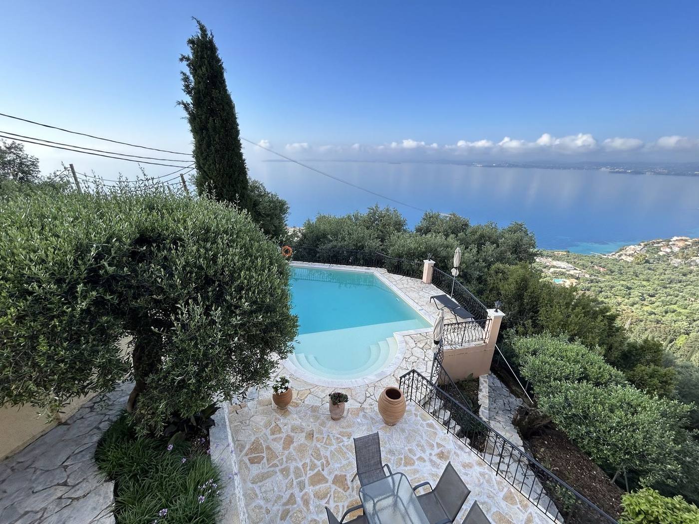 The pool from above, with a cypress and the whole bay behind
