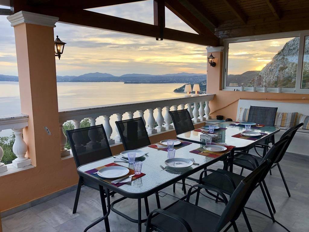 The balcony dining table laid for dinner at dusk