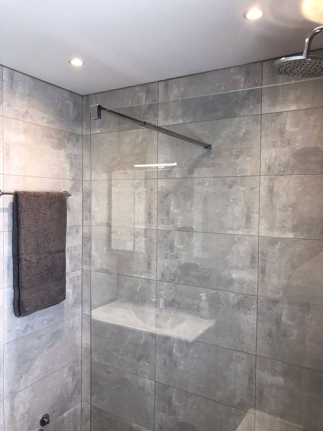 Walk-in rain shower in one of the renovated bathrooms