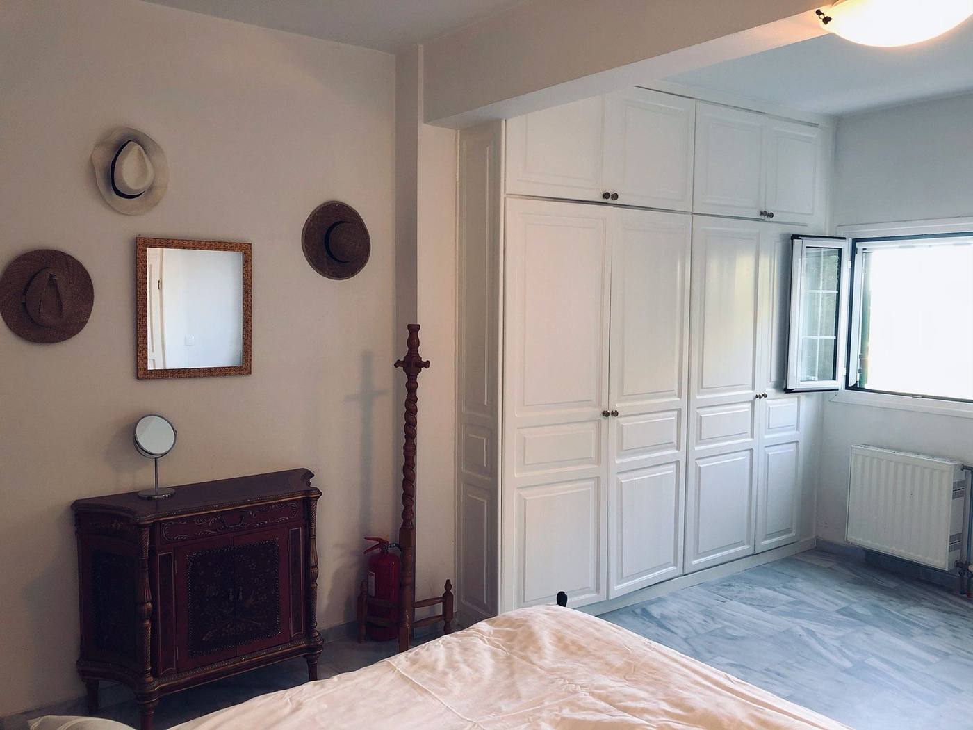 Bedroom with an antique chest and fitted wardrobes