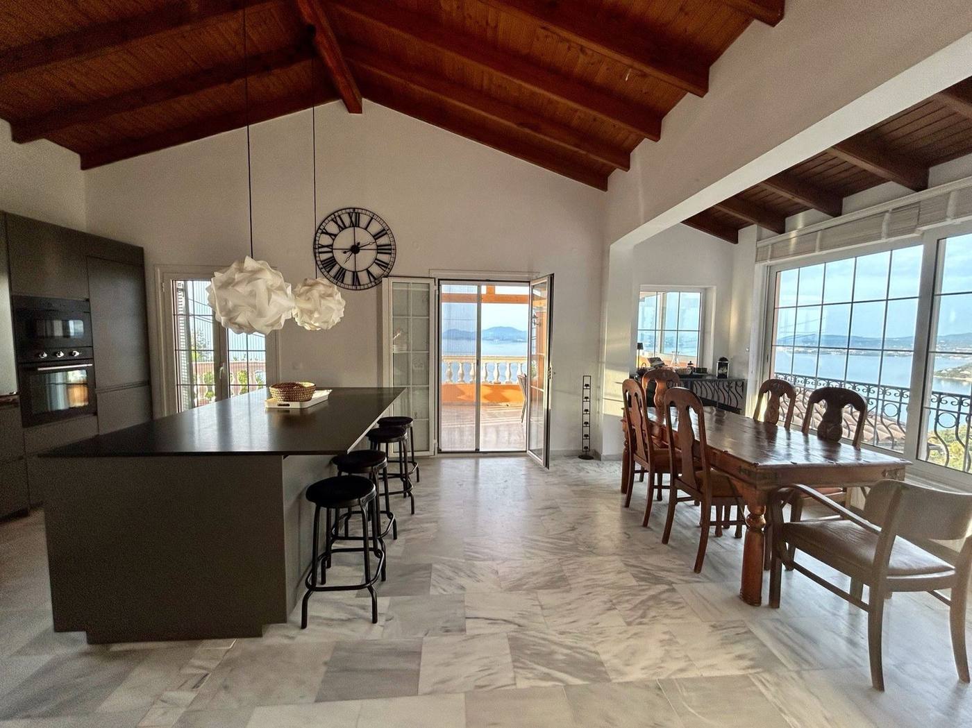 Kitchen island and dining table under the timber ceiling
