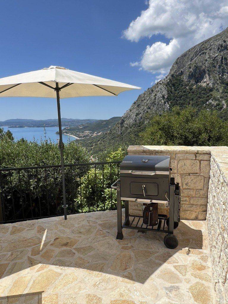 The BBQ under a parasol, with the mountain behind