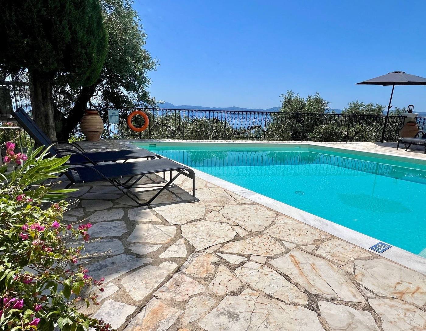 Stone paving, sun loungers and the pool edge
