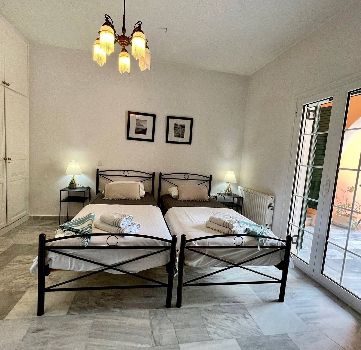 Bedroom with two single beds and towels laid out