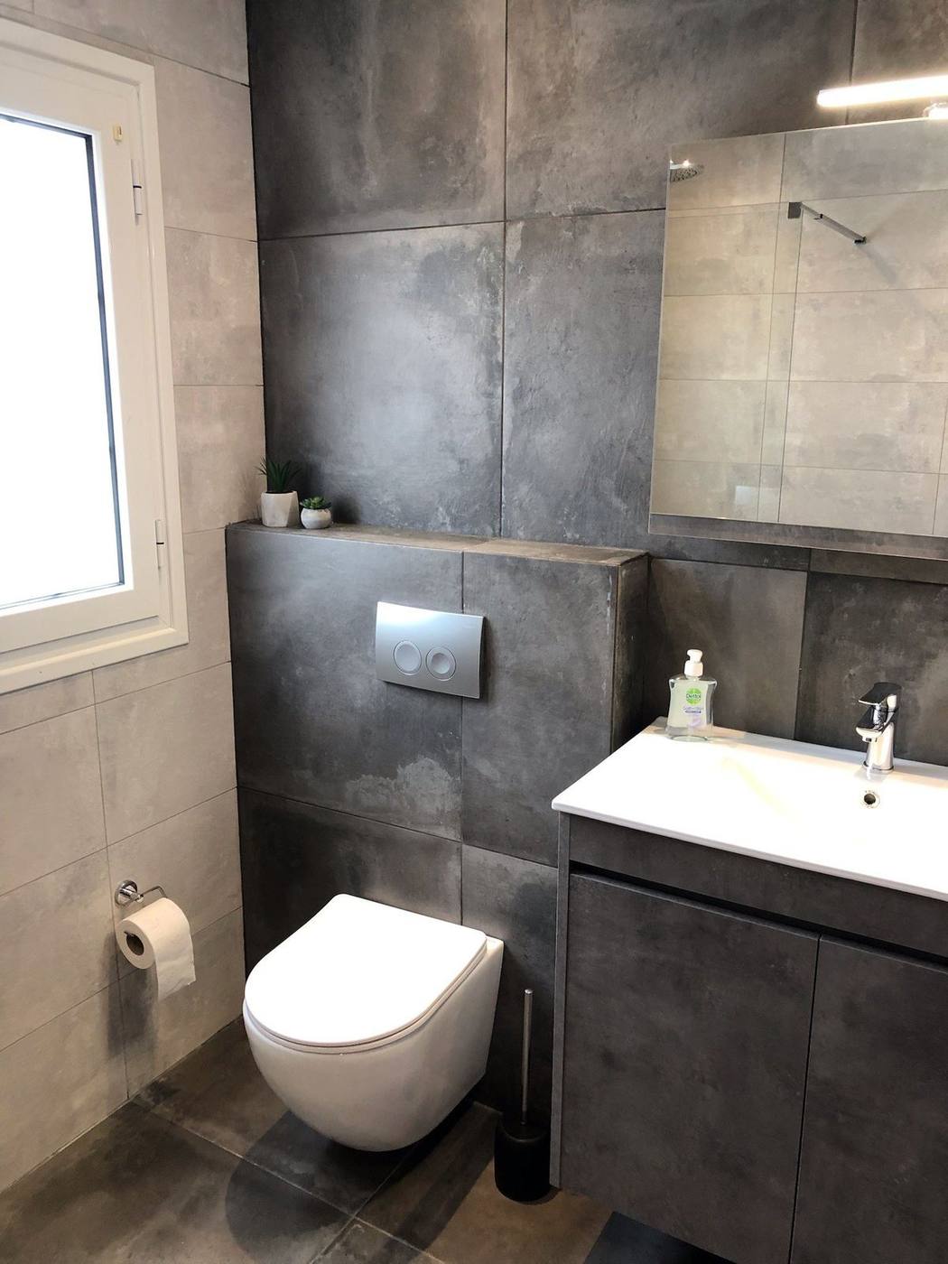 Renovated bathroom with vanity unit