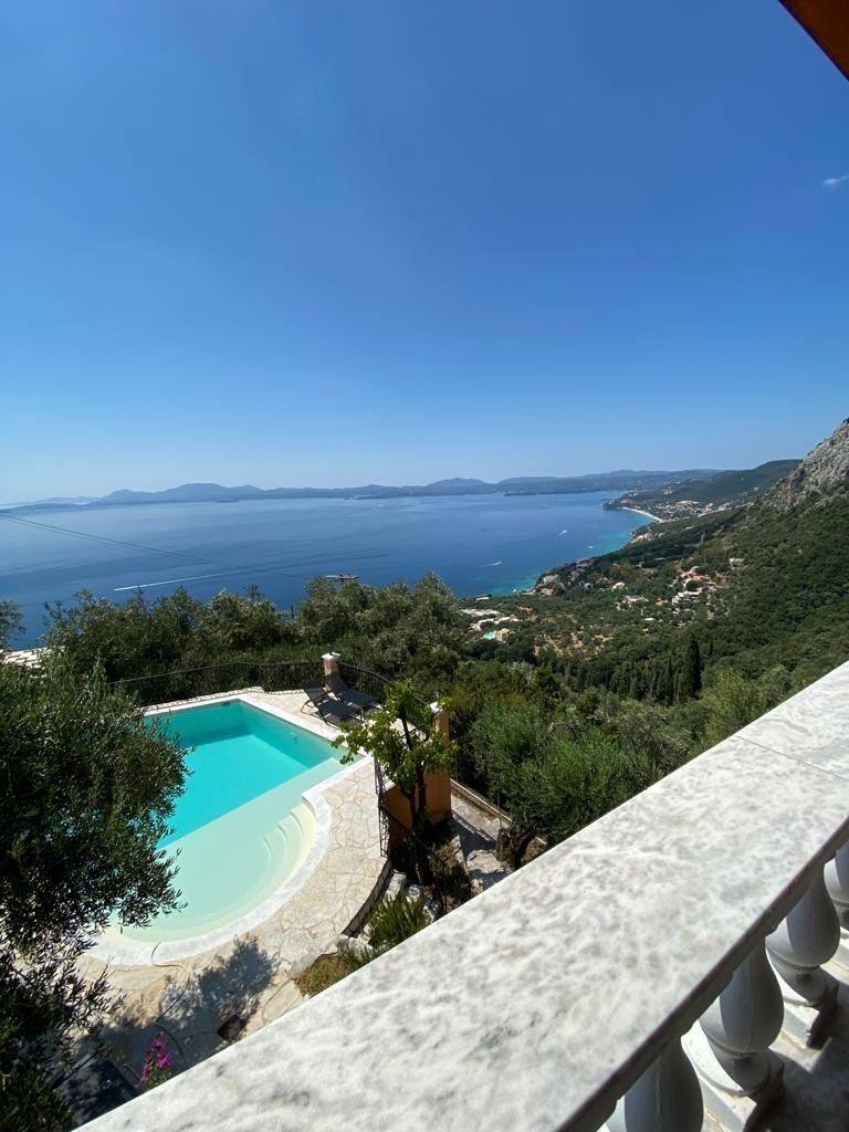 The pool far below the balcony, with the bay beyond